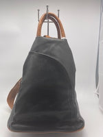 
              Black backpack with brown double straps
            