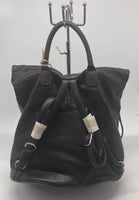 
              Black soft backpack with silver zipper
            